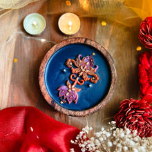 Load image into Gallery viewer, Decorative soy wax candle with multi coloured Autumn themed floral design on a blue surface, in a wooden bowl. Handcrafted artisanal festive candle