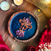 Load image into Gallery viewer, Decorative soy wax candle with multi coloured Autumn themed floral design on a blue surface, in a wooden bowl. Handcrafted artisanal festive candle